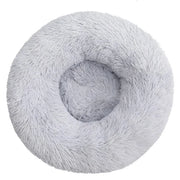 Cat curled in round donut bed showing rim support