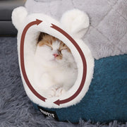 Deep plush interior of covered cat bed house that traps body heat